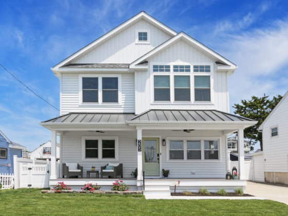 Charming beach house with a well-maintained lawn.
