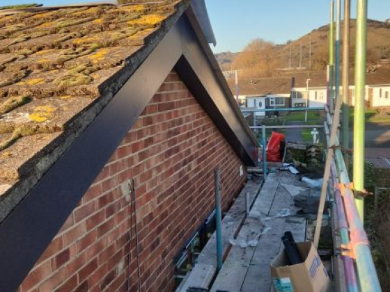 Rooftop view with scaffolding along brick wall