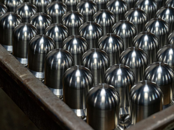 Shiny metal cylinders arranged neatly on a tray