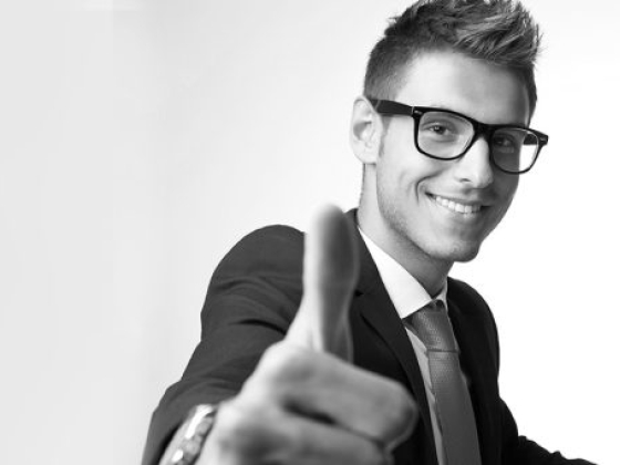 Confident businessman smiling and gesturing approval