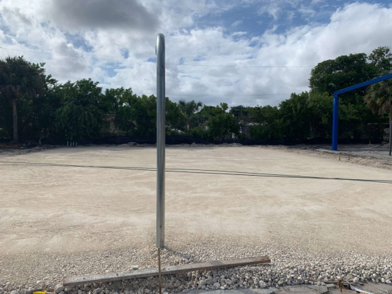 Bare construction site with a pole and blue structure