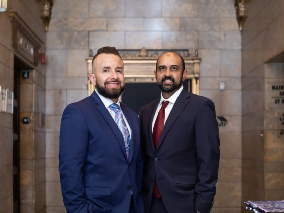 Two men smiling in a formal setting