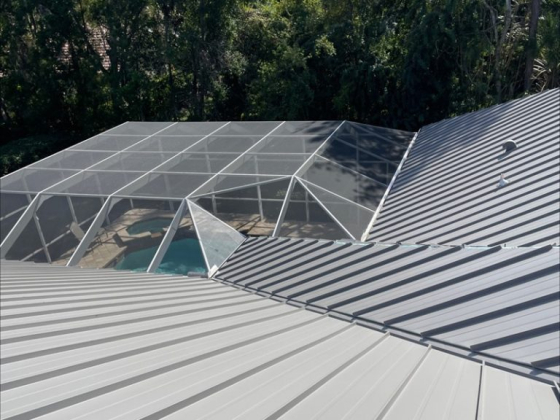 Aerial view of metal roof and screened pool area