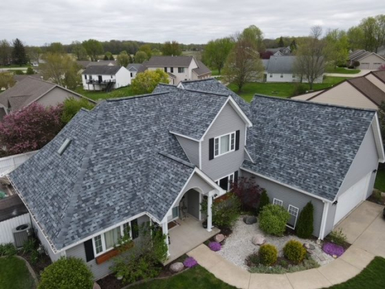 Suburban home with landscaped garden and gray roof