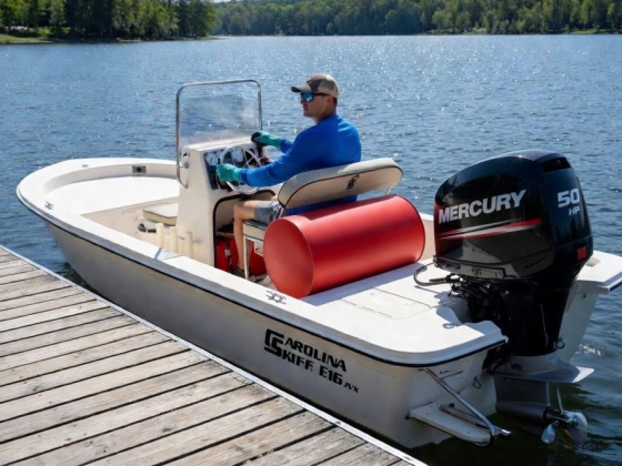 Man driving a Carolina Skiff boat with a 50 HP engine