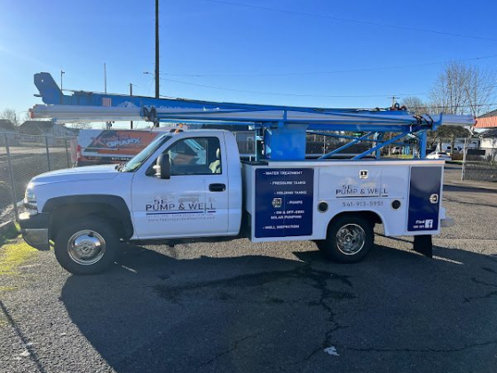 Utility truck with mounted blue equipment in parking lot