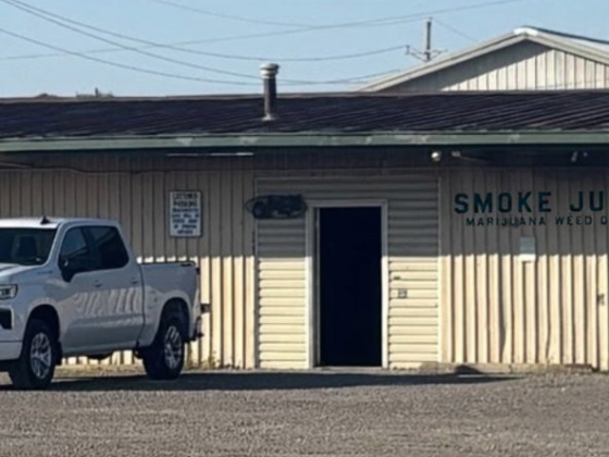 A white truck outside a marijuana shop