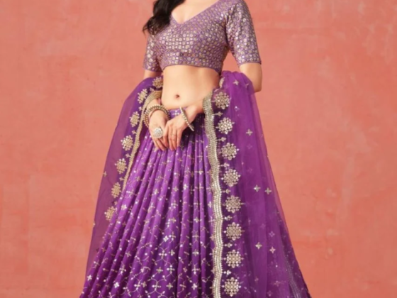 Model wearing a purple traditional Indian lehenga