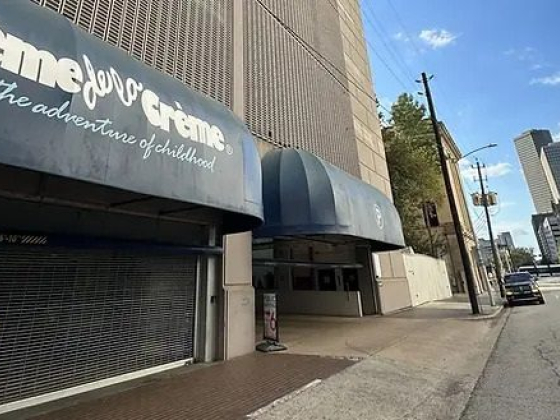 A closed Crème de la Crème building in city setting