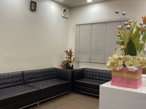 Stylish waiting area with floral arrangement and sofas
