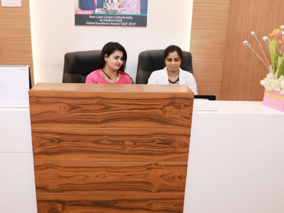 Receptionists working at front desk of laser center