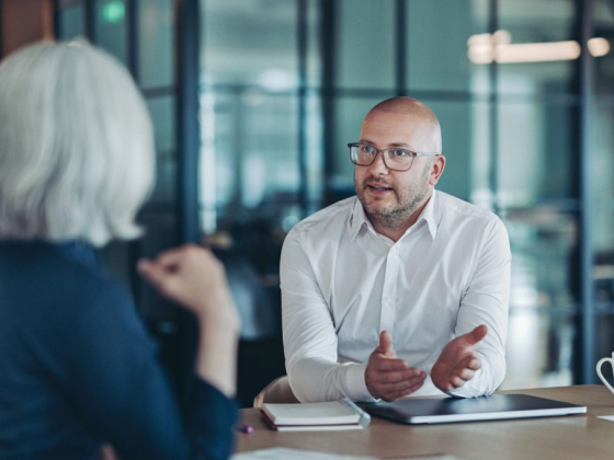 Colleagues discussing work at an office table