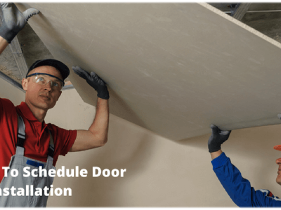 Workmen in protective gear fitting ceiling panel
