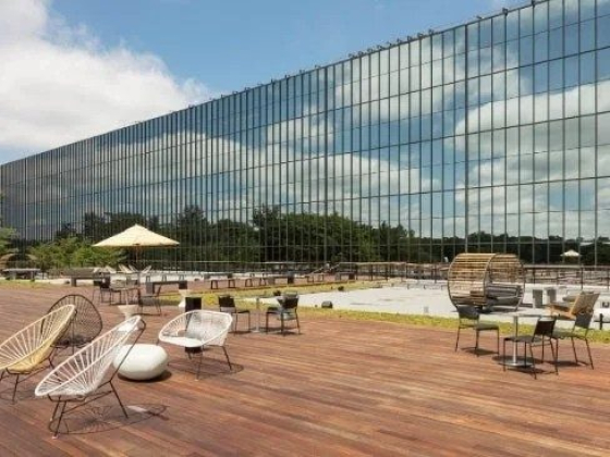 Modern outdoor seating with glass building reflections