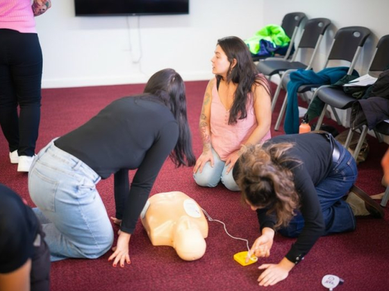 CPR training session with participants and a practice dummy