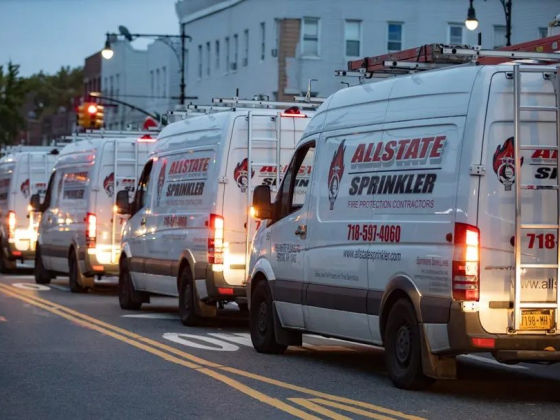 Fleet of service vans parked along urban roadway