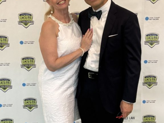 Dressed in formal attire, posing together.