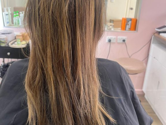 Person with long hair sitting in a salon chair