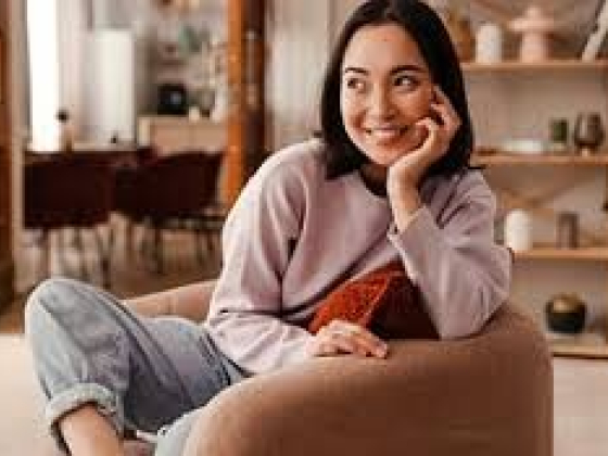 Smiling woman sitting comfortably in a modern living space