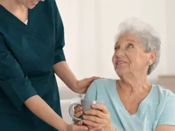 Nurse helping a senior woman in a wheelchair