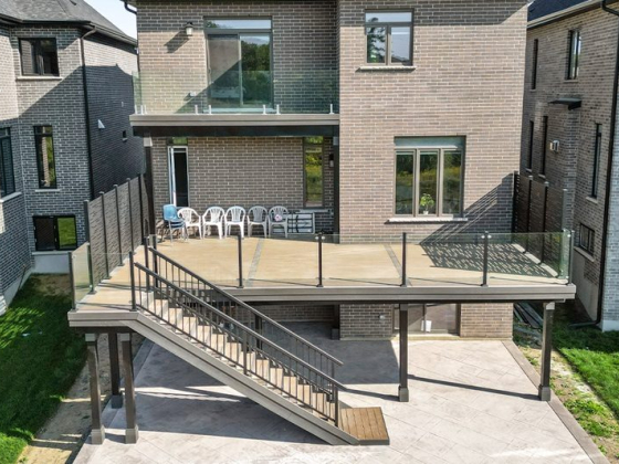 Modern house with elevated deck and glass railing