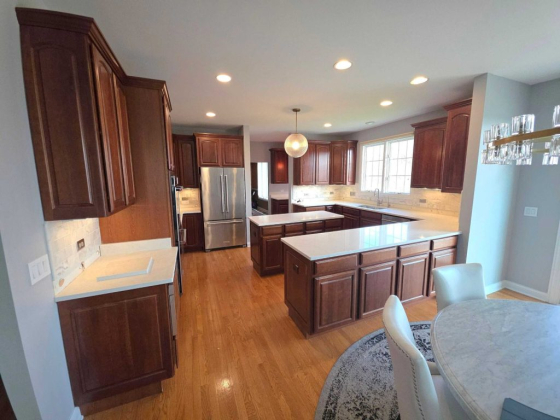 Modern kitchen design featuring wood floors and ample lighting