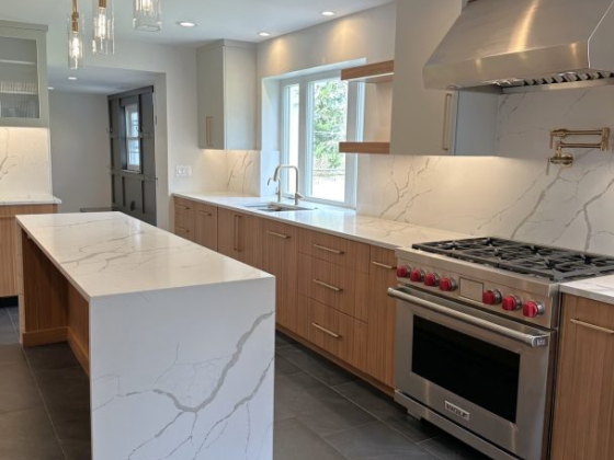Sleek kitchen design featuring marble countertops and stainless steel appliances