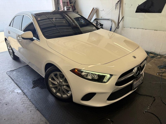 A clean white car parked indoors