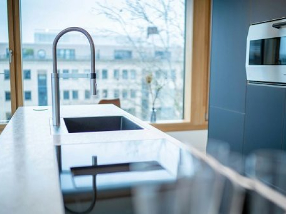 Contemporary kitchen featuring a minimalist faucet and appliances
