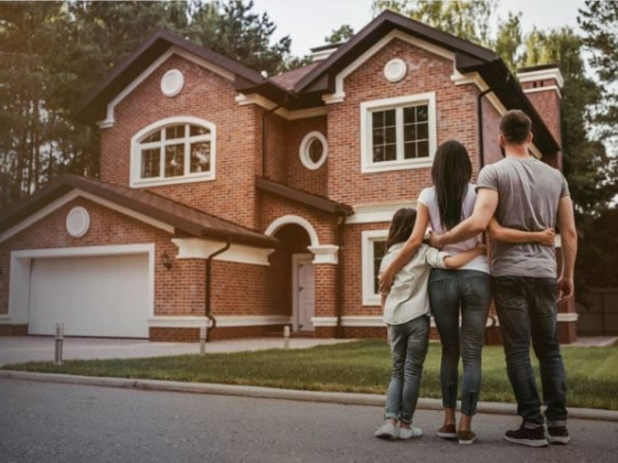 Family admiring their new home from the driveway