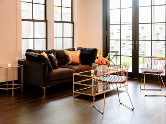 Stylish seating area with dark sofa and gold accents