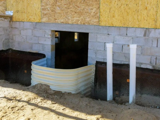 Construction site with window well installation
