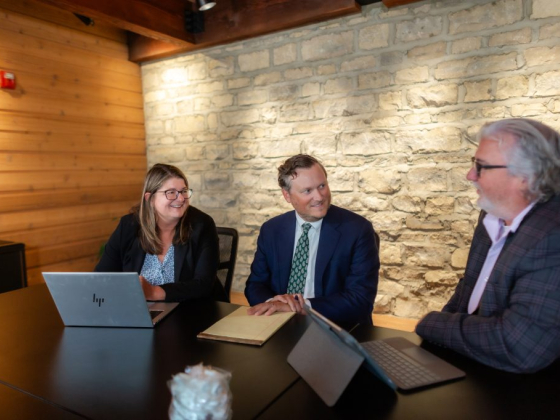 Colleagues discussing work around a table