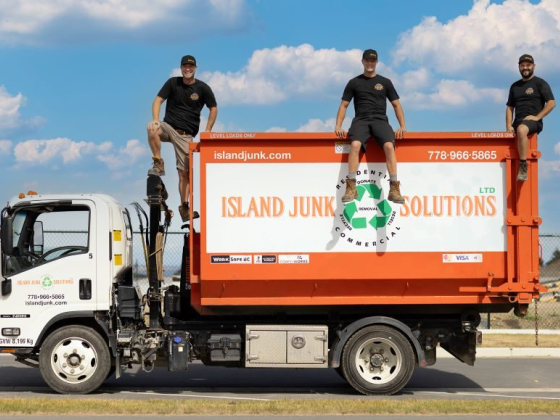 Island Junk Solutions truck with people on top