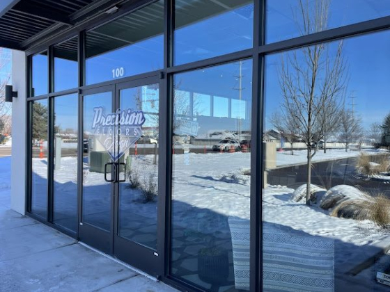 Exterior of Precision Floors shop with snow on ground