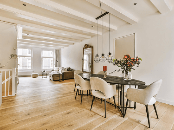 Spacious, light-filled living space with dining table and seating