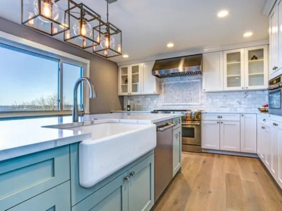 Bright kitchen with white cabinets and wooden floor
