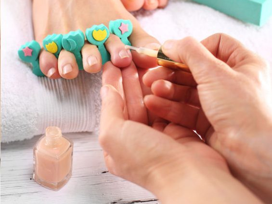 Close-up of pedicure with pastel nail polish