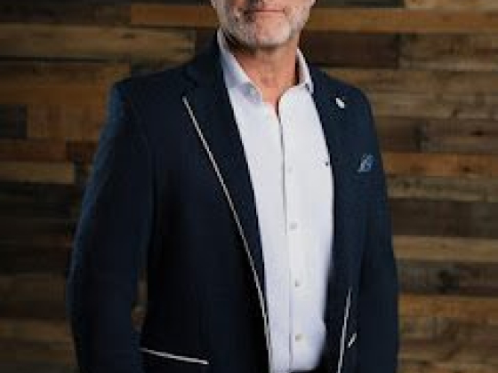 Confident man in suit against rustic wooden background