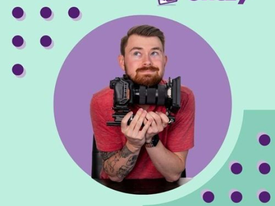 A man with tattoos poses with a camera on Chezy-themed design