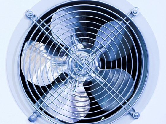 Detailed view of a silver fan behind a grill