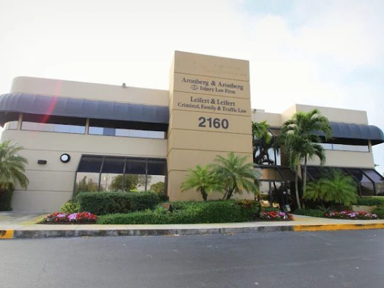 A spacious law firm building with lush greenery outside