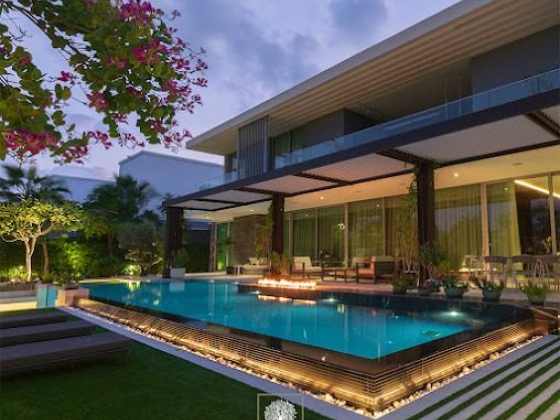 Elegant house with illuminated pool and garden