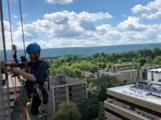 Rope access worker operates on a high-rise building