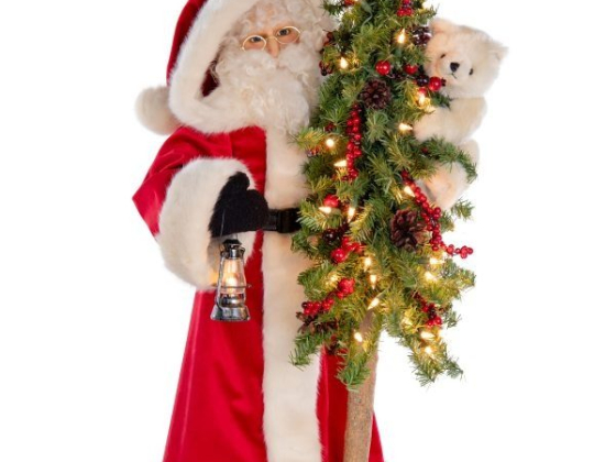 Santa holds a lantern and festive Christmas tree