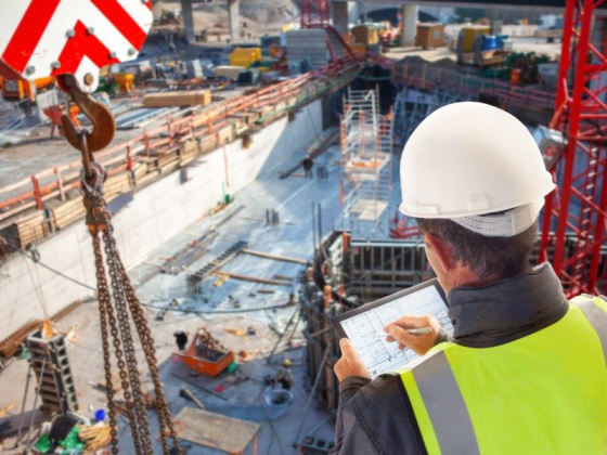 Construction worker assesses project progress