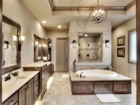 Spacious bathroom featuring a tub and dual vanities.