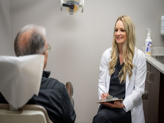 Dentist discussing with a patient in a clinic