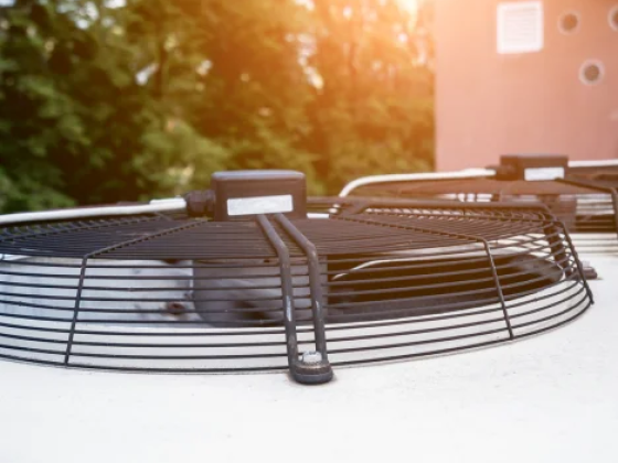 Top view of an AC unit fan in sunlight.