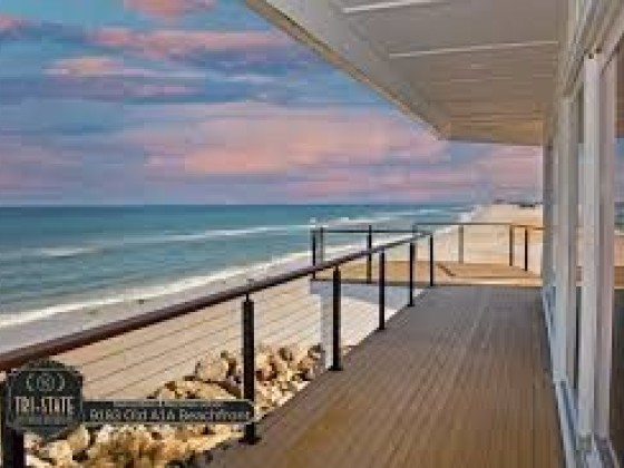 Scenic beachfront with a wooden deck and ocean view